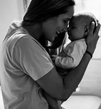 grayscale photo of man kissing womans cheek