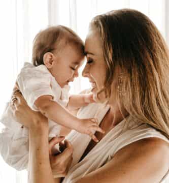 smiling woman carrying baby