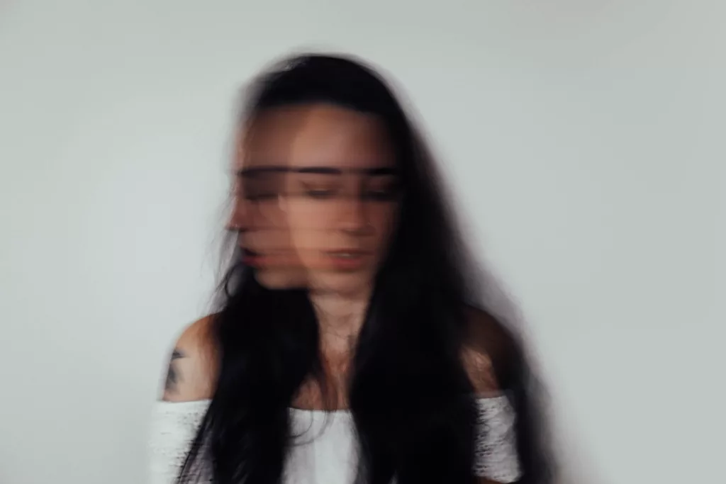 a blurry photo of a woman with glasses