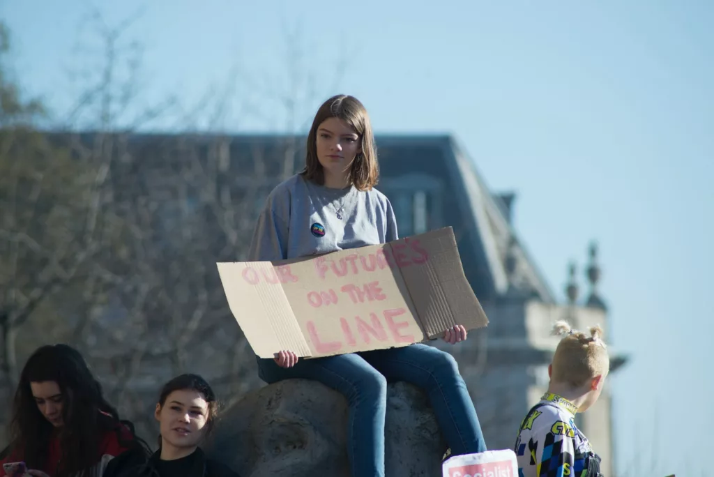 woman holding cardboard signage